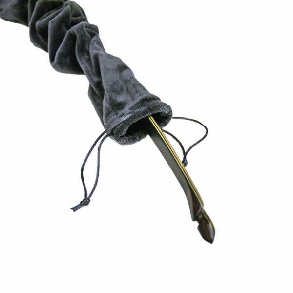 Closeup photo the tip of  the White Feather Hugin Longbow coming out of a velvety draw string bag.